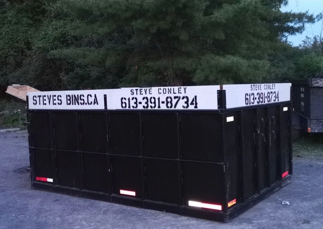 Steve's Bins branded black roll-off disposal bin, up close